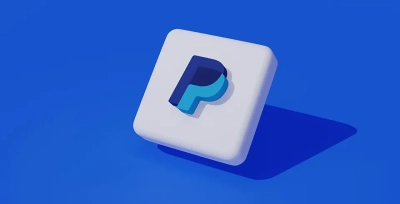 A floating 3D PayPal logo cube casting a shadow on a solid blue background.